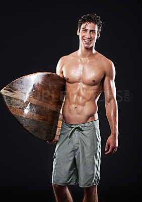 Buy stock photo Studio shot of a young surfer with a vintage board