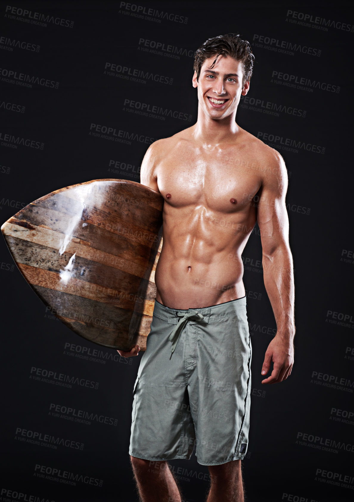 Buy stock photo Studio shot of a young surfer with a vintage board