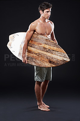 Buy stock photo Male surfer and vintage board in studio at night with body, stomach and strong or healthy. Young wave rider, backdrop or wood or retro accessory in portrait for sports, fitness or confidence and dark