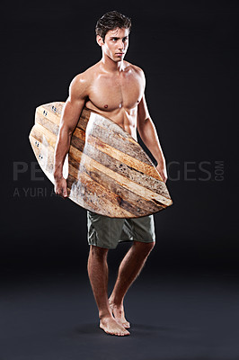 Buy stock photo Full length studio shot of a young surfer with a vintage board