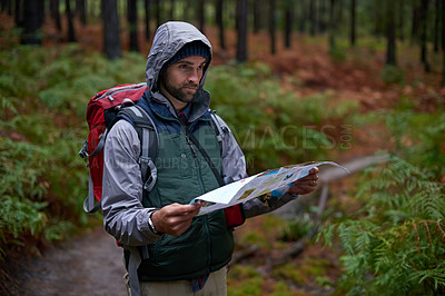 Buy stock photo Search, map and man lost in forest with guide to camp in woods or thinking of navigation or direction. Confused, travel and trekking in nature with backpack or plan to find location on hiking journey