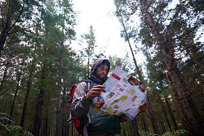 Buy stock photo Hiking, forest and man search map for direction to camp on adventure in woods and reading navigation. Confused, travel and lost in nature trekking with backpack, plan and guide to location on paper