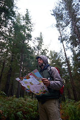 Buy stock photo Lost, man and search forest with map as guide to camp in woods and thinking of navigation or direction. Confused, travel and trekking in nature with backpack and plan to location on hiking journey