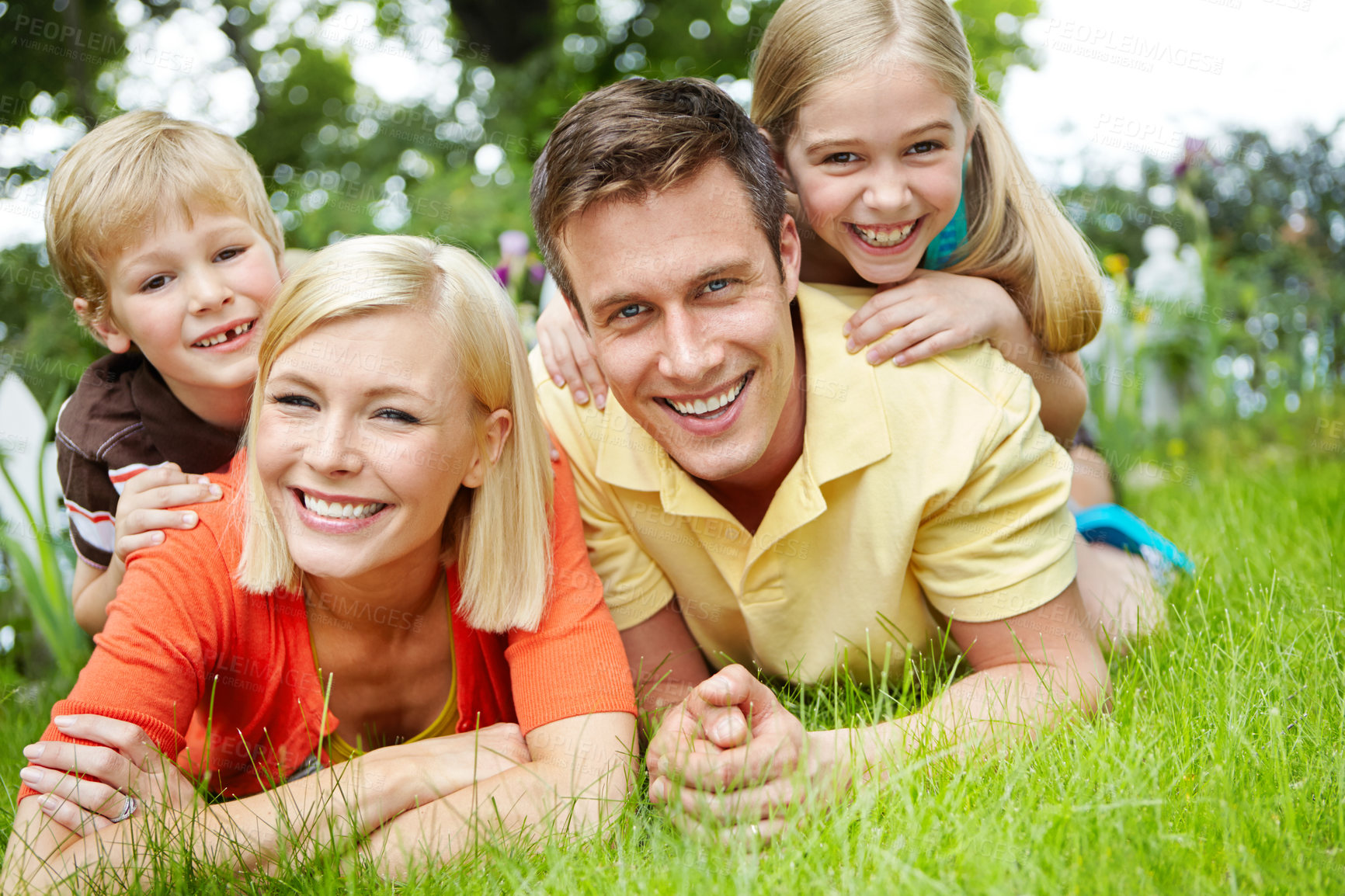 Buy stock photo Parents, kids and happy with lying on grass at garden for support, care and love in Canada. Park, family and smile or playful on portrait for fun, holiday and break for child growth and development