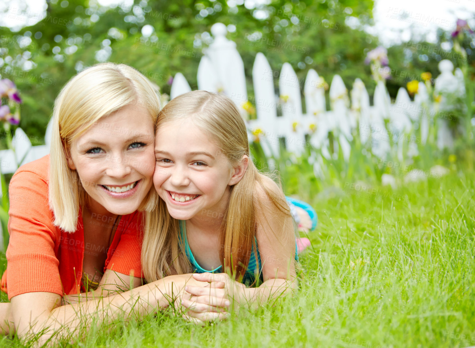 Buy stock photo Cute little girl lying on the grass outdoors with her mom