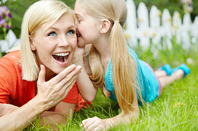 Buy stock photo Cute, whisper and child with mom, outdoor and wow for gossip, rumor and telling of secret to woman. Home, sneaky and girl with news for mother, backyard and surprised with information and family