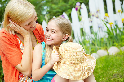 Buy stock photo Happy mom, daughter and garden with hat for summer holiday, weekend or bonding together in outdoor backyard. Mother, young child or little girl with smile for love, youth or fun childhood in nature