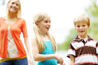 Buy stock photo Two cute young children spending time outdoors with their mother