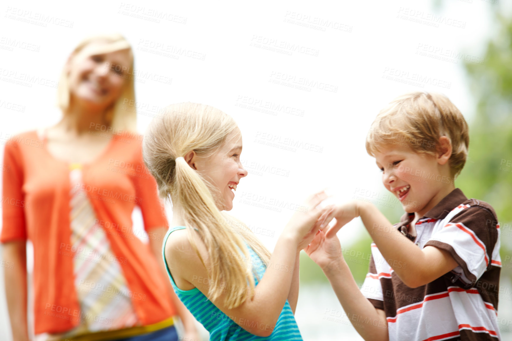 Buy stock photo Two cute young children spending time outdoors with their mother