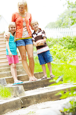 Buy stock photo Two cute young children spending time outdoors with their mother