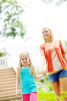 Buy stock photo Happy little girl standing outdoors and smiling with her mother