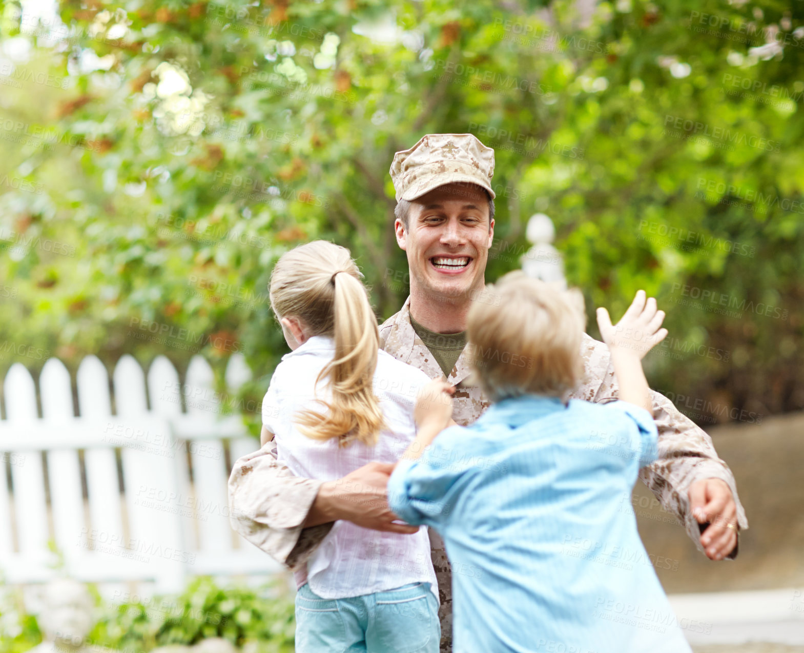 Buy stock photo Outdoor, soldier and smile for children, hug and excited for reunion, dad and hero with love or kids. Family, father and parent from military, embrace and care for boy, girl and man after war or home