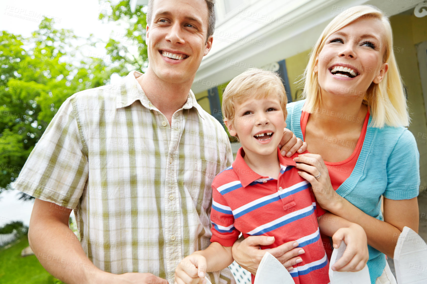 Buy stock photo Happy family, bonding and hug with child in backyard for playful summer or weekend in garden together. Mother, father and young kid with smile or laughing for holiday or fun childhood in nature
