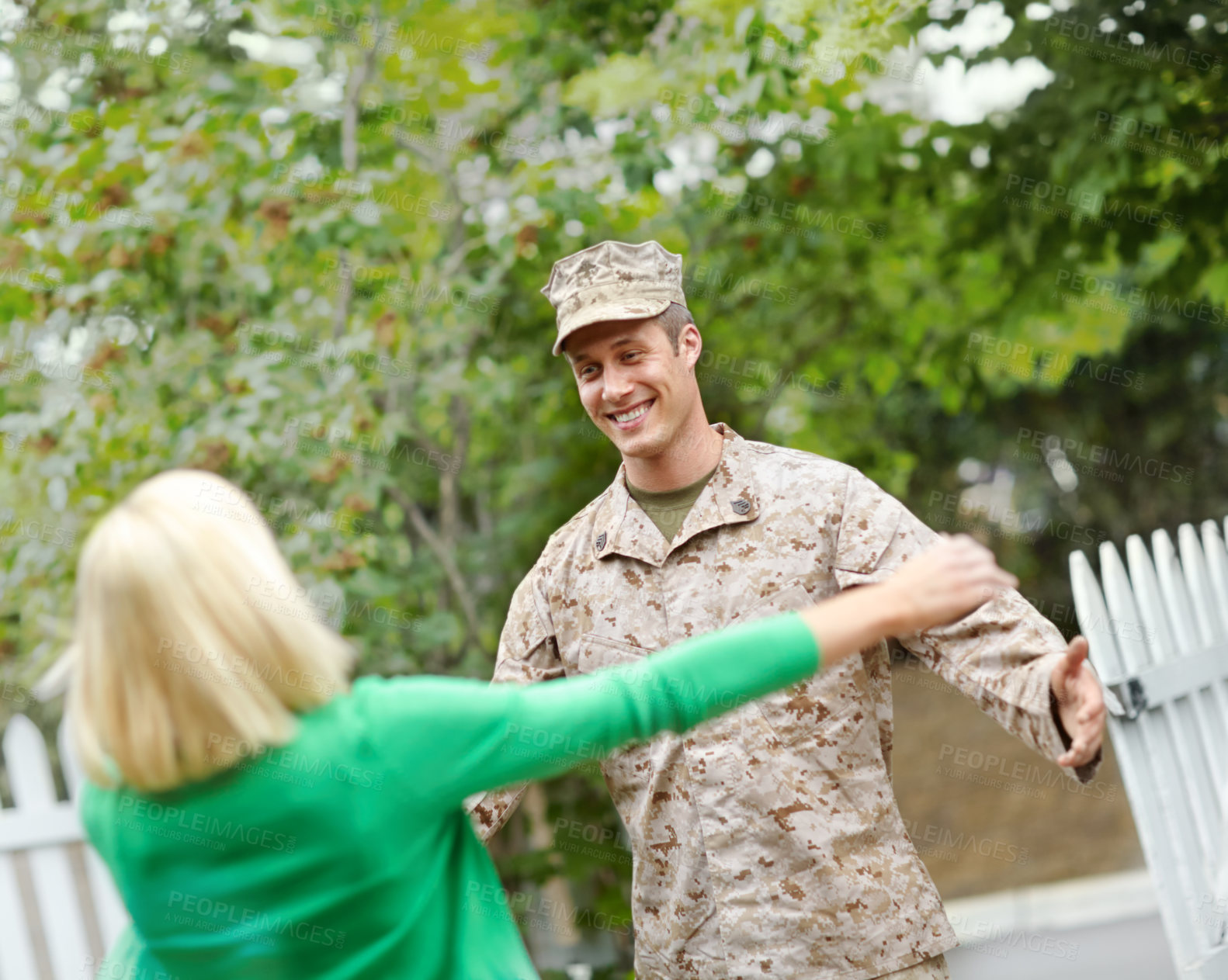 Buy stock photo Happy, woman and welcome for army partner of emotional celebration, hug and safety of military service return. Man, soldier and wife with embrace for reunion together, patriotism and house garden