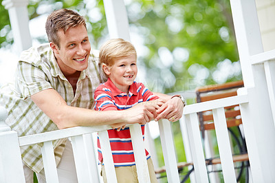 Buy stock photo A young boy and his father sharing some quality together on the porch