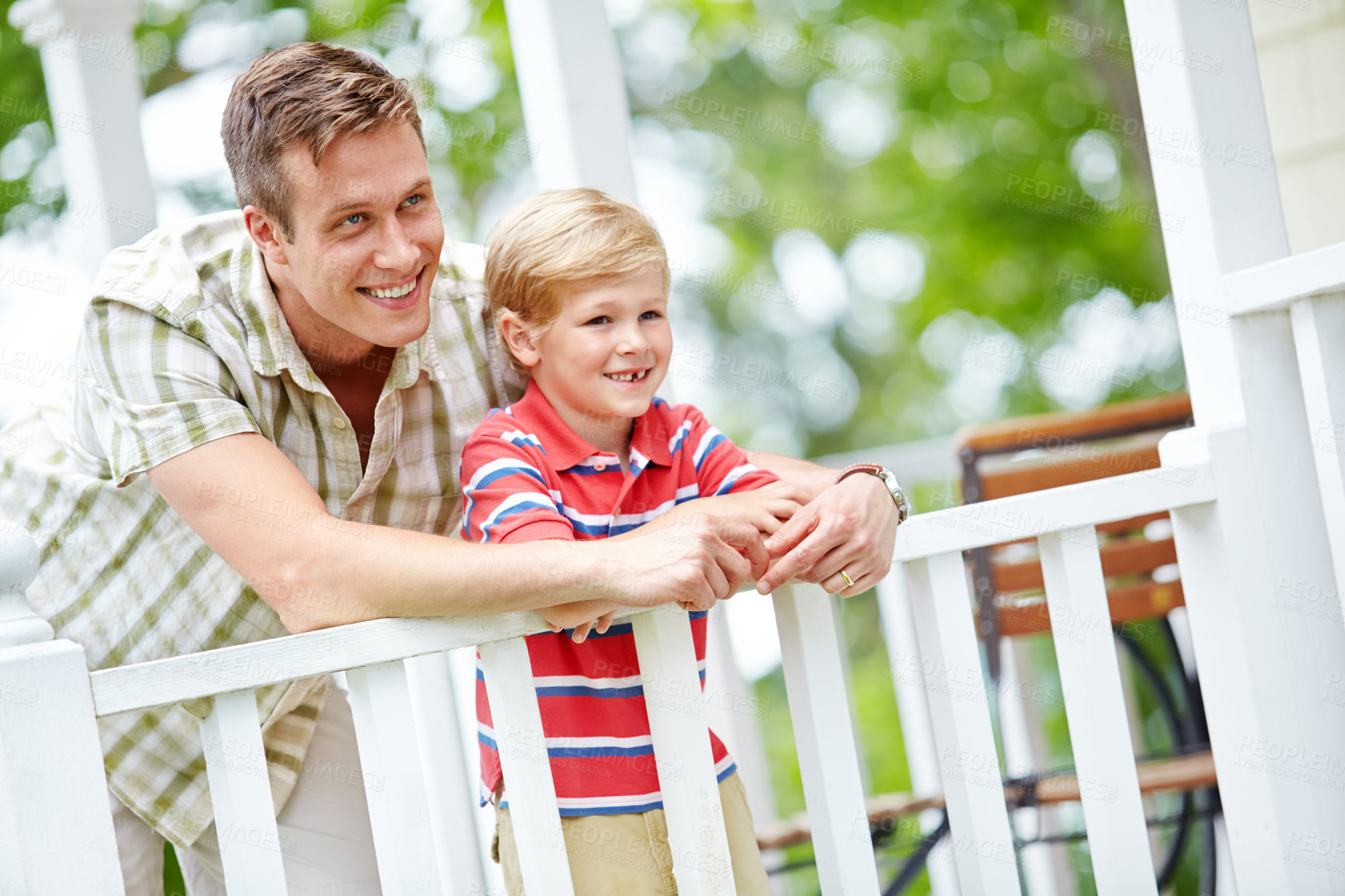 Buy stock photo A young boy and his father sharing some quality together on the porch
