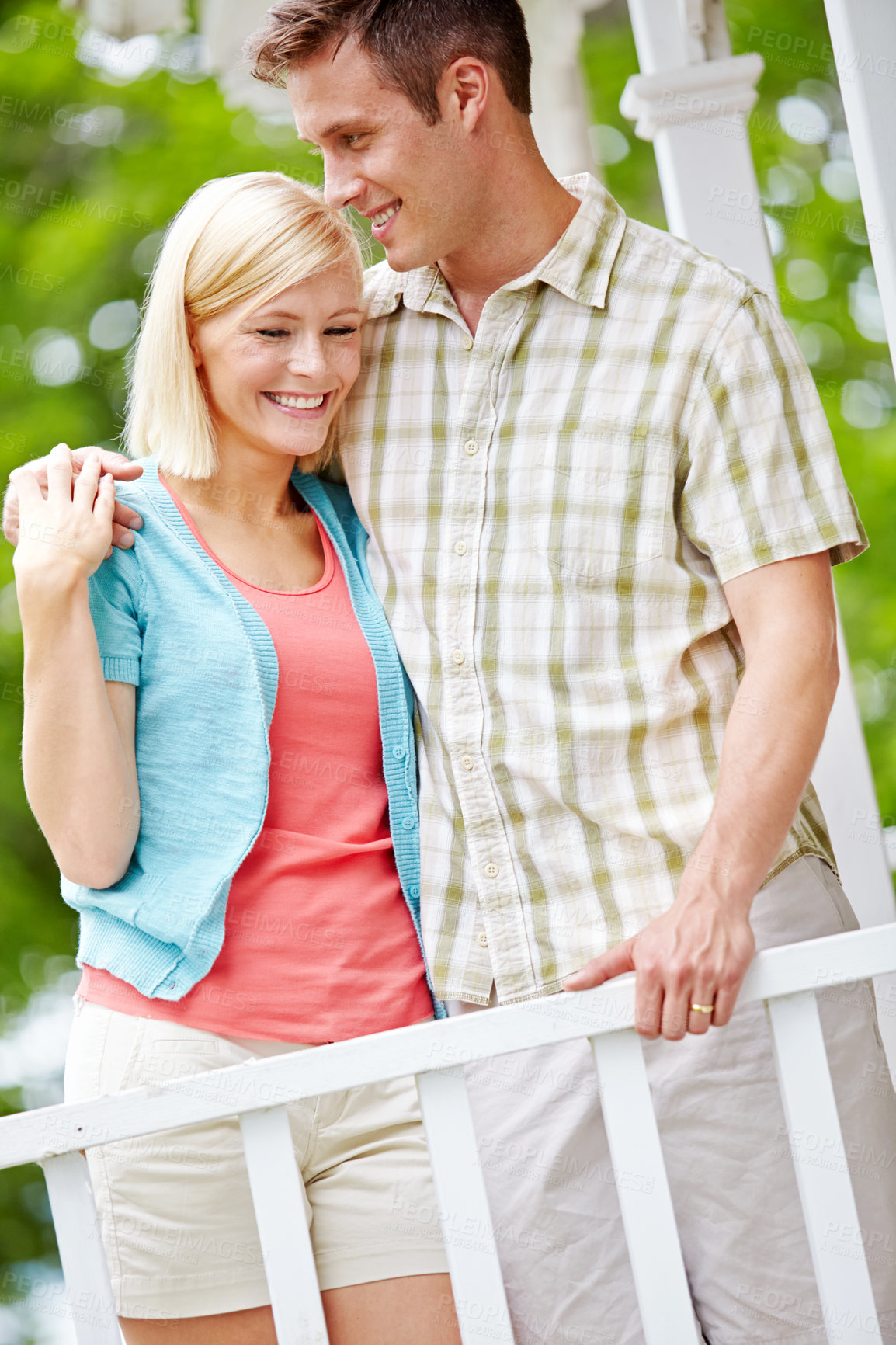Buy stock photo Happy, hug and love with couple on porch in garden of home for bonding, romance or support. Security, smile or trust with man and woman embracing on backyard veranda for moment or relationship
