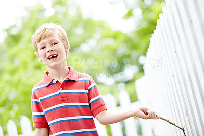 Buy stock photo Smile, portrait and playful with kid and picket fence for fun, break and summer vacation. Happiness, explore and childhood development with young boy in backyard of home for holiday and outdoors