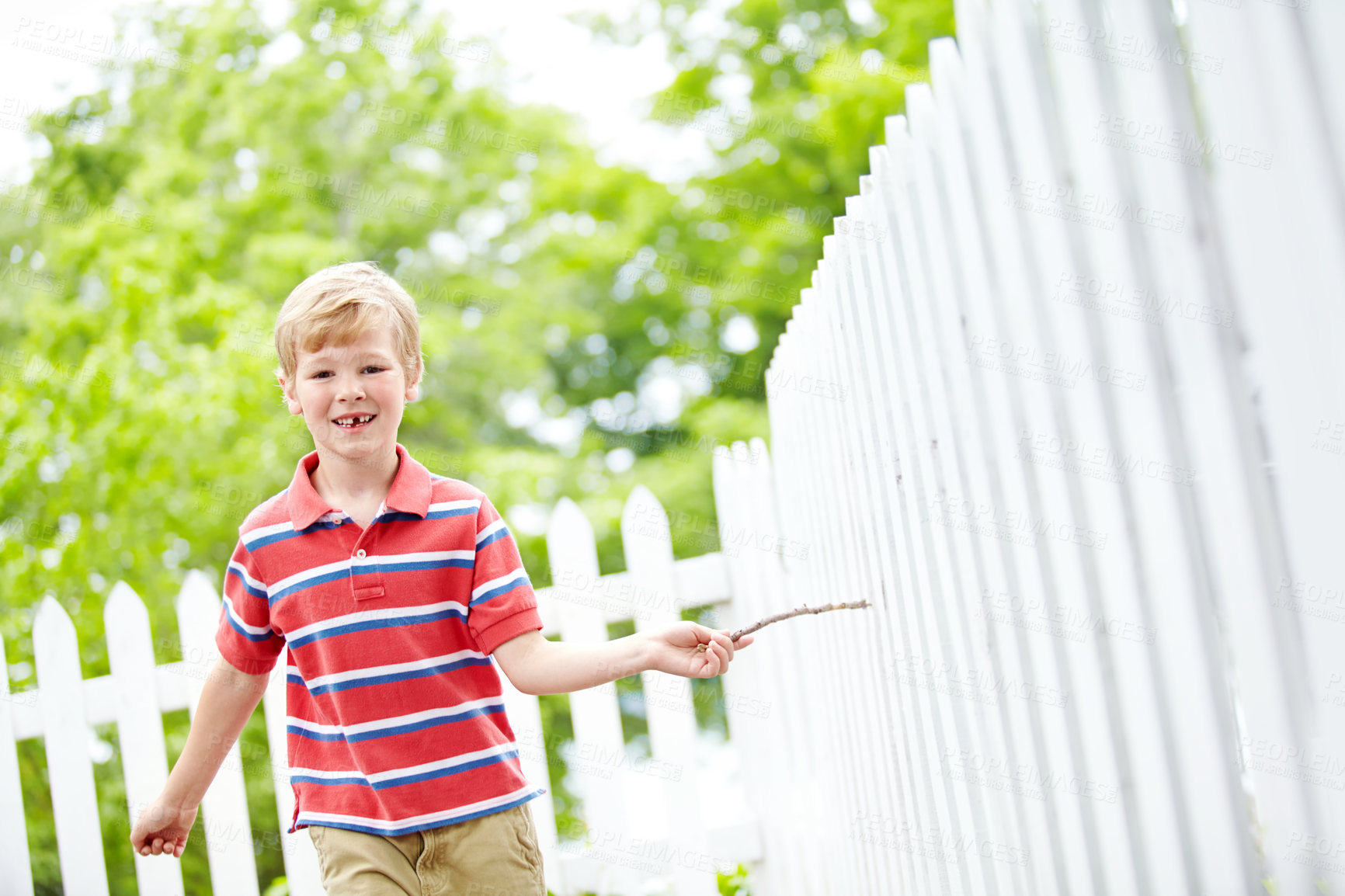 Buy stock photo Smile, portrait and running with kid and picket fence for fun, break and summer vacation. Happiness, playful and childhood development with young boy in backyard of home for holiday and outdoors