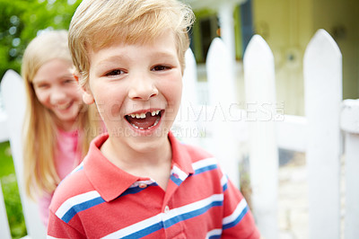 Buy stock photo Kid, boy or portrait for teeth loss in garden with dental milestone, oral development or happy with sibling. Health, child or pride for growth, childhood memory or missing tooth with wellness outdoor