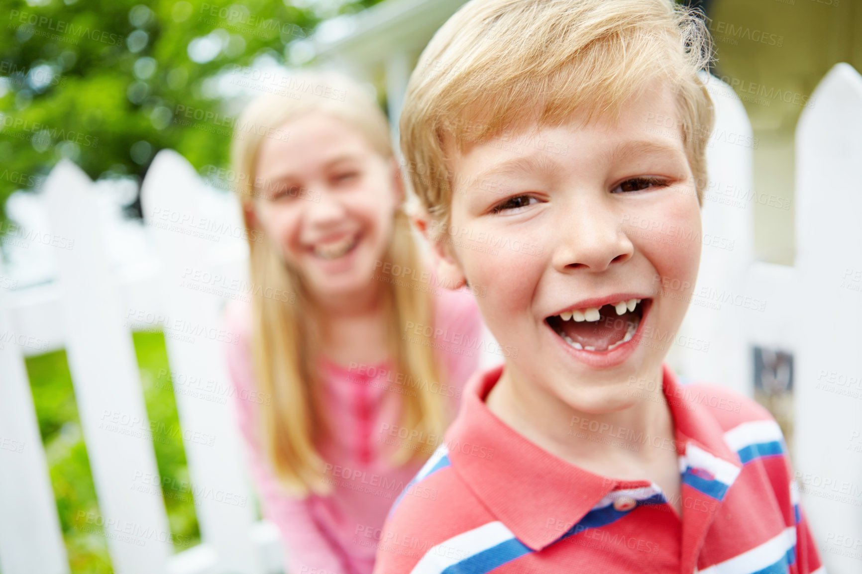 Buy stock photo Kid, boy and portrait with tooth in garden for dental milestone, oral development and happy with sibling. Health, child and pride for growth, childhood memory or missing teeth with wellness by house