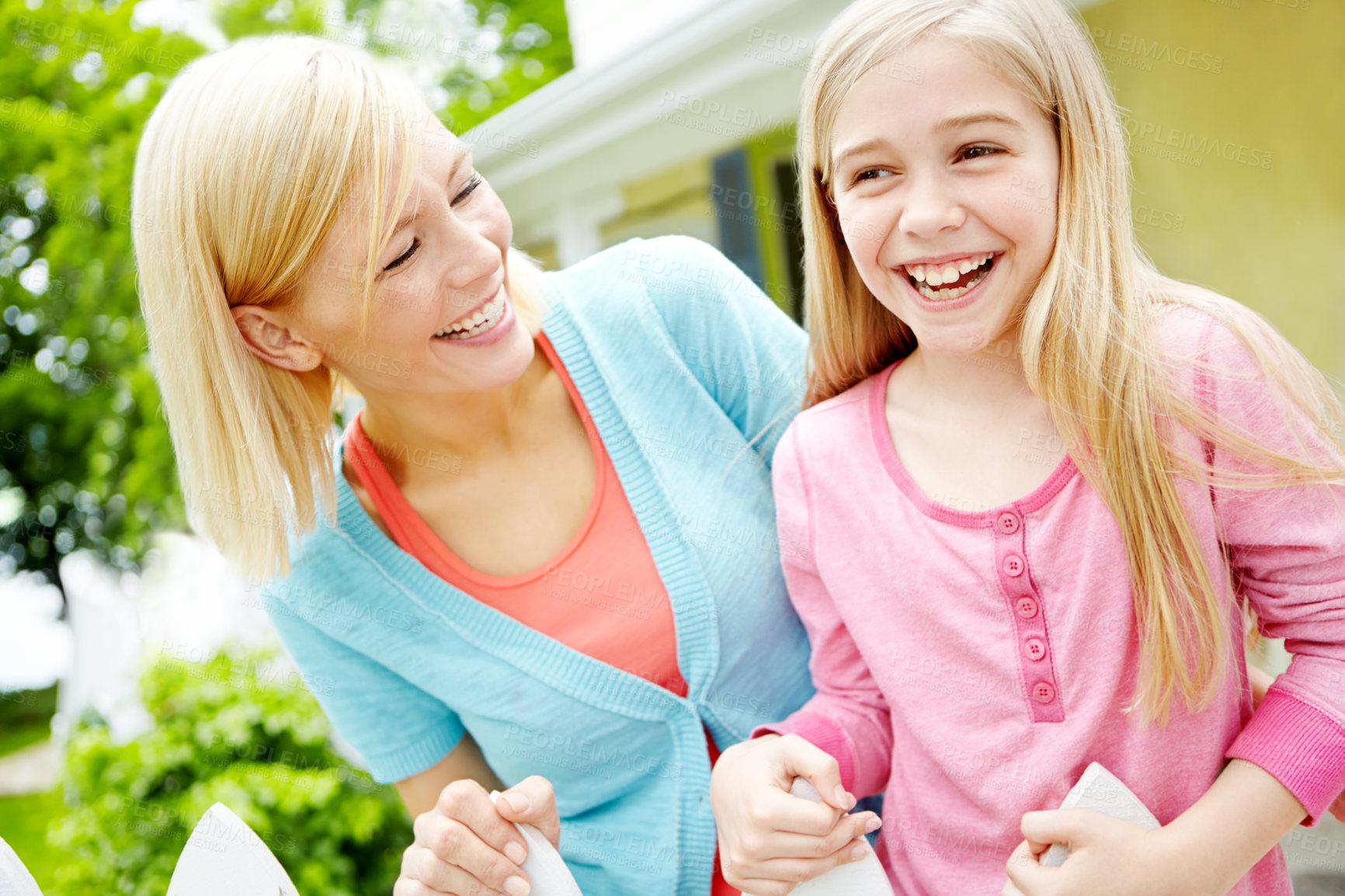 Buy stock photo Laughing, happy mother and child at backyard for love, joke or comedy at garden fence by home.  Funny, girl and kid with mama outdoor for family connection, support or daughter with parent at house