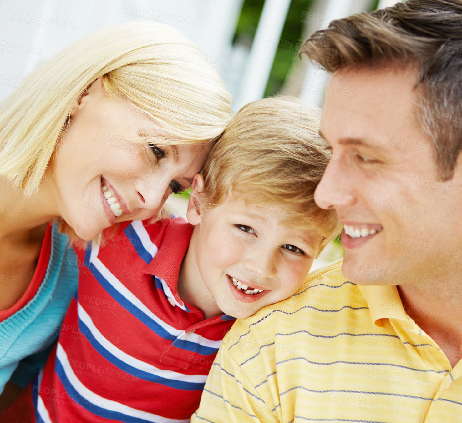 Buy stock photo Happy young family sitting together outdoors