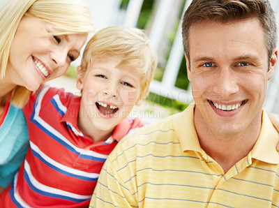 Buy stock photo Happy young family sitting together outdoors