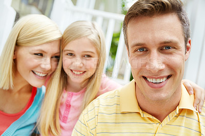 Buy stock photo Happy young family sitting together outdoors