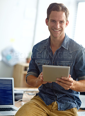 Buy stock photo A young man reading his text messages while standing in his office