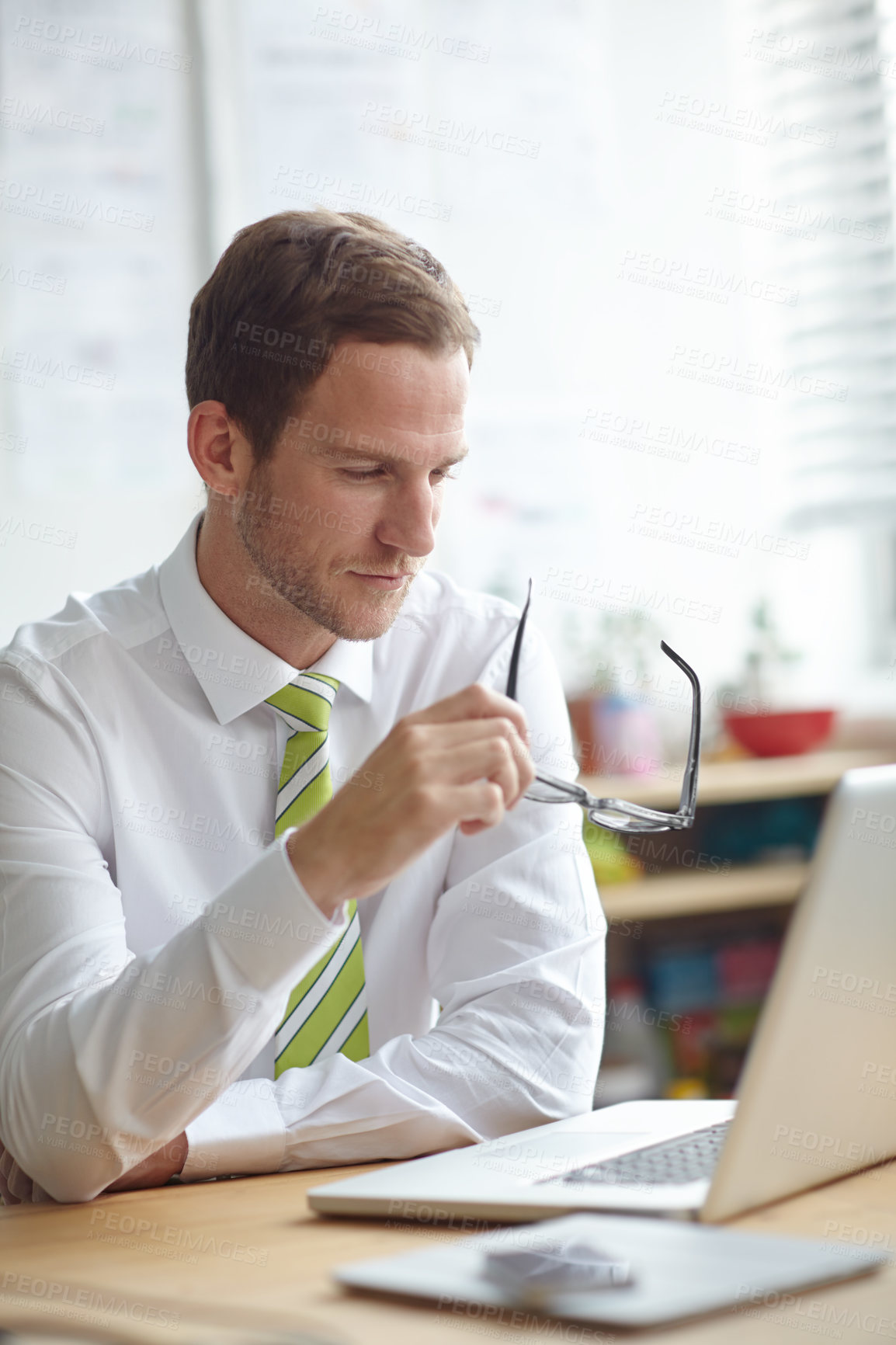 Buy stock photo Thinking, glasses and businessman on laptop in office for brainstorming, problem solving and solution. Professional, corporate and person on computer for planning, research proposal and website news