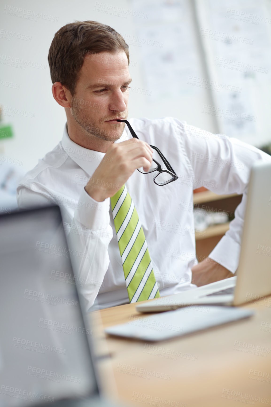 Buy stock photo Man, laptop and choice with thinking in office with story, proposal and confused at media company. Person, writer and computer for editing, article and biting glasses for solution at news agency