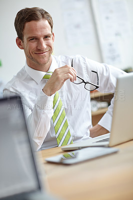 Buy stock photo Confident, office and portrait of business man with glasses for reading, company pride and happy. Professional, corporate and person with laptop for planning, research proposal and project review