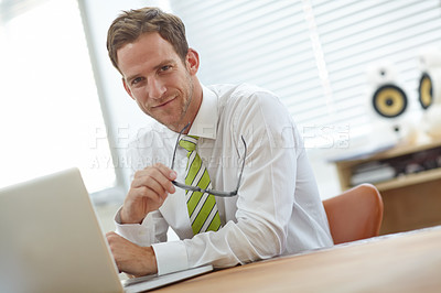 Buy stock photo A young businessman sitting behind his laptop