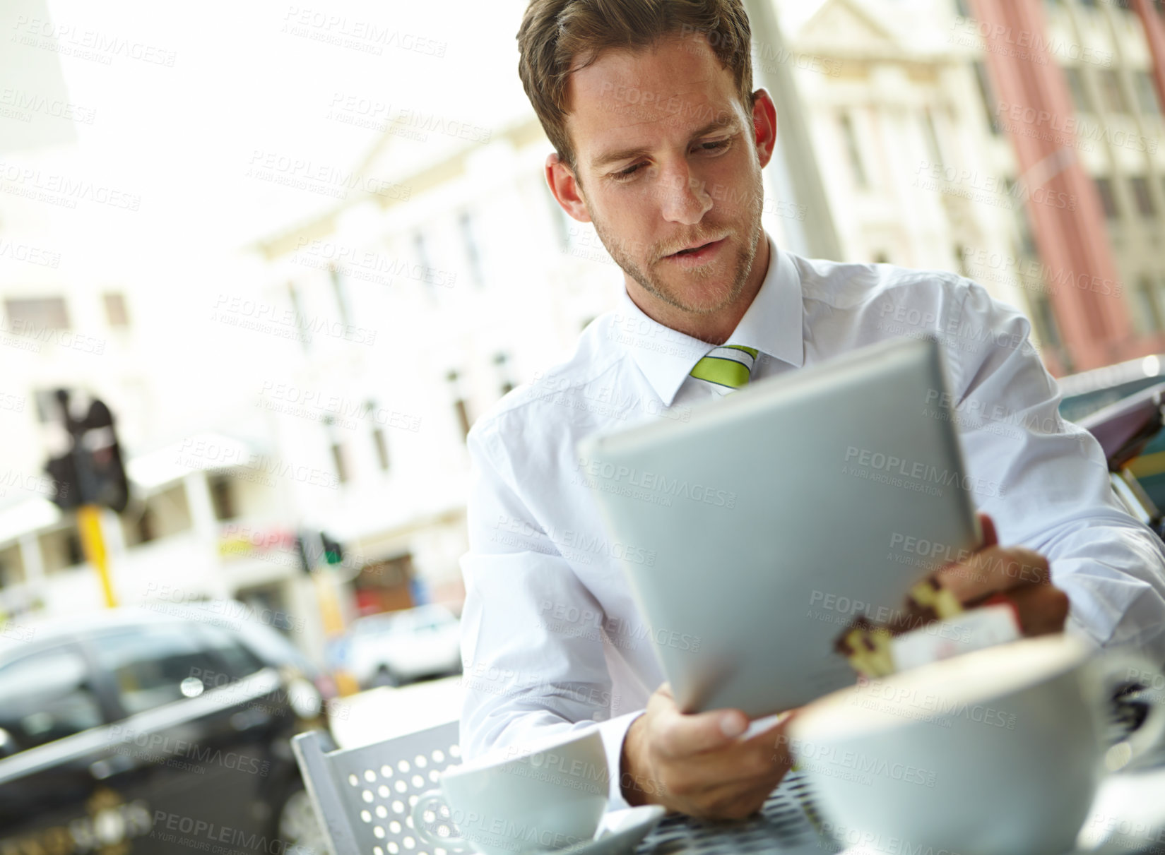 Buy stock photo Business man, tablet and reading at coffee shop in morning with remote work, notification and chat. Person, lawyer and digital touchscreen with application, thinking or social media on break at cafe