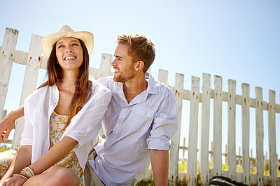 Buy stock photo Nature, love and outdoor couple relax, happy and enjoy quality time together on lawn, grass field or picnic mockup. Park fence mock up, sky and people bond on summer holiday in Portugal countryside
