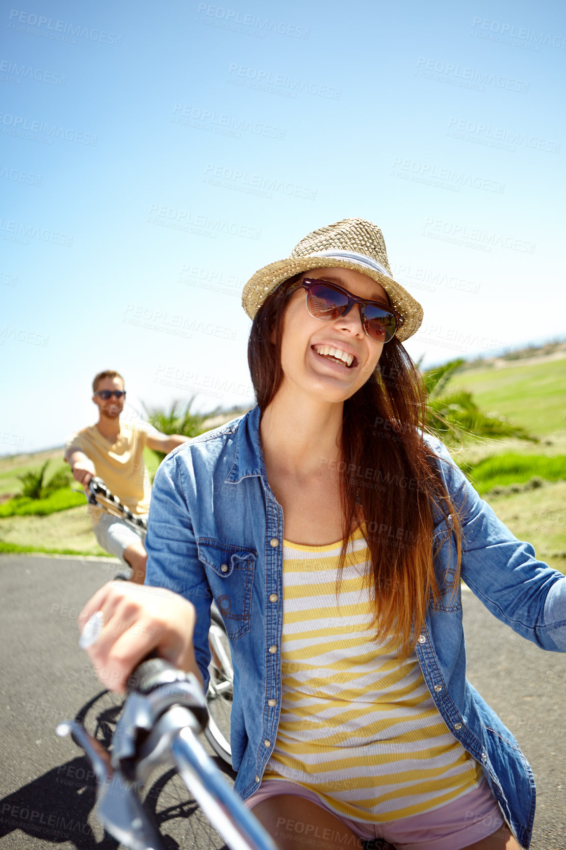 Buy stock photo Cycling, travel and woman on couple vacation, summer holiday fun outdoor riding on blue sky background. Bicycle, smile and happy date with partner on bike ride, freedom and happiness with love in sun