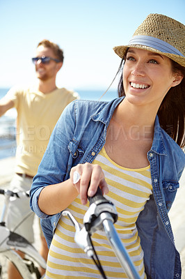 Buy stock photo Bike, travel and couple with a woman on summer vacation or holiday riding on the promenade by the beach. Freedom, date and romance with a girlfriend outdoor for a ride on the coast during the day