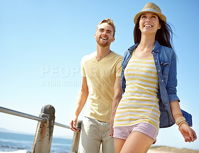 Buy stock photo Love, travel and couple at the beach for summer, fun and romance while walking against a blue sky background. Happy couple, laughing and young man with woman relax, break and bond in Florida together