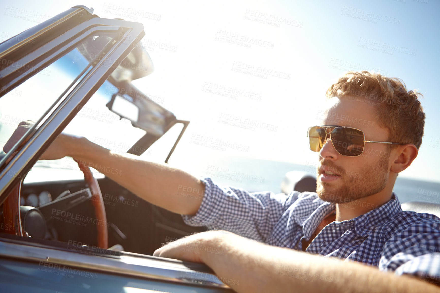 Buy stock photo Car travel, road trip and relax man driving on holiday adventure, transportation journey or fun summer vacation. Lens flare, convertible automobile and driver on outdoor Australia countryside tour