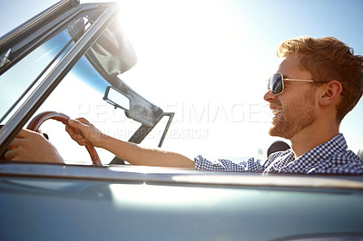 Buy stock photo Happy, young man and driving for summer vacation, road trip or journey for freedom in the outdoors. Male taking a drive in car with smile enjoying outdoor travel on a warm sunny day with sunglasses