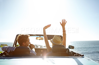 Buy stock photo Car, road trip and travel with a couple by the beach on a drive to enjoy the view during summer together. Freedom, transport and driver with a woman sitting hands raised by the ocean with her man