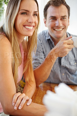 Buy stock photo An attractive young couple enjoying a cup of coffee in restaurant