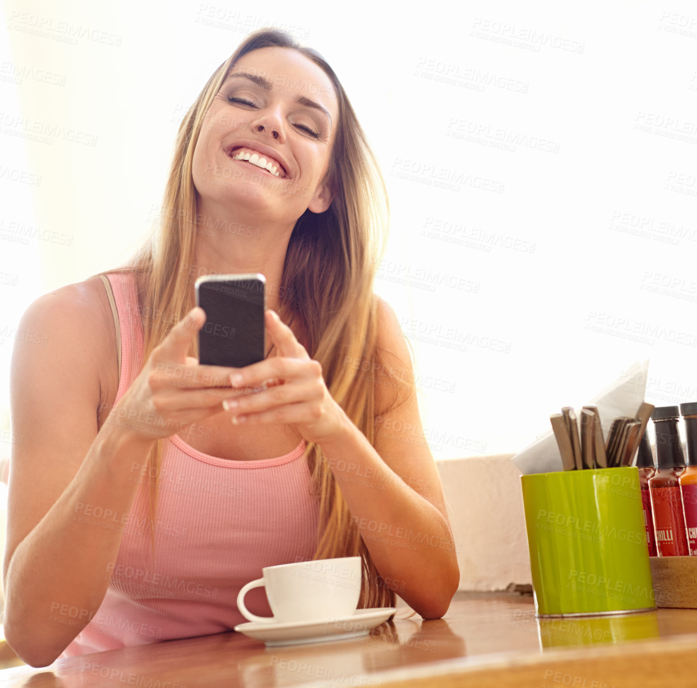 Buy stock photo Phone, typing and woman in cafe with laughing, drink and smile at social media post at table. Smartphone, relax and happy girl networking in coffee shop on mobile app for funny online chat connection