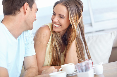 Buy stock photo An attractive young couple enjoying a cup of coffee in restaurant