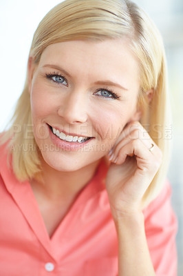 Buy stock photo Attractive blonde woman smiling while relaxing at home