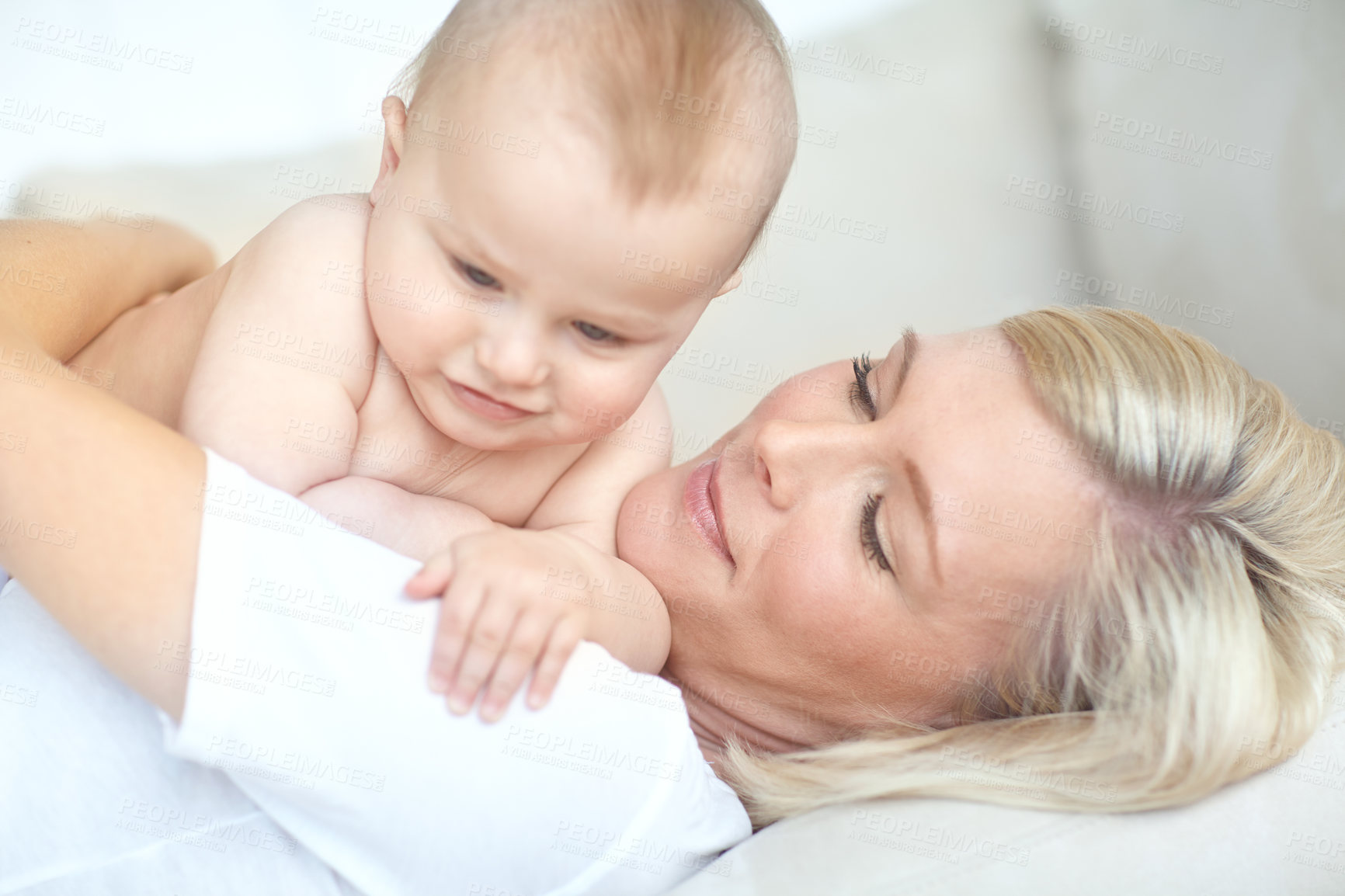 Buy stock photo Mom, baby and relax in home with bonding for love, care and support with maternity leave for motherhood. People, parent and infant at apartment for fun, safety and child development or growth