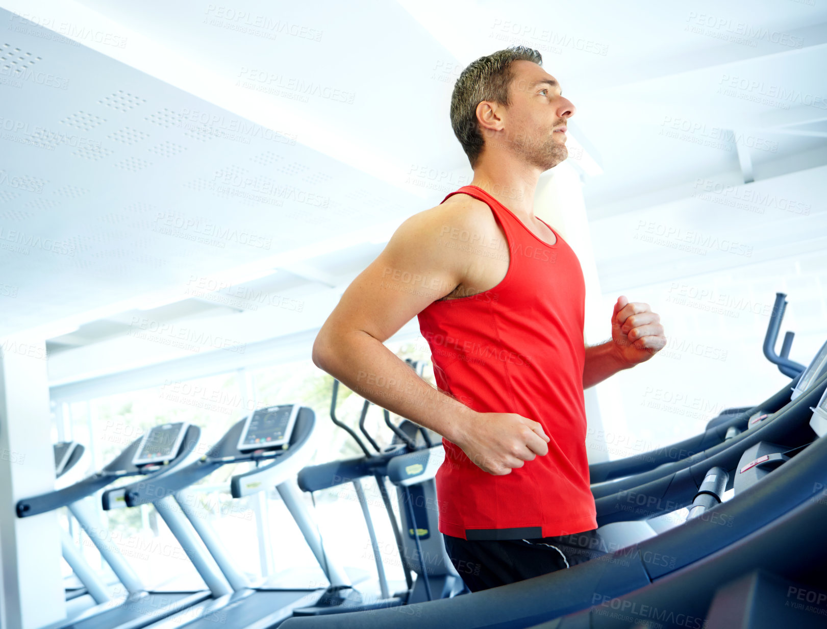 Buy stock photo Athlete, fitness and running with treadmill for marathon, workout or cardio training in gym. Man, exercise or sports person ready with equipment for endurance, speed goals or wellness in health club