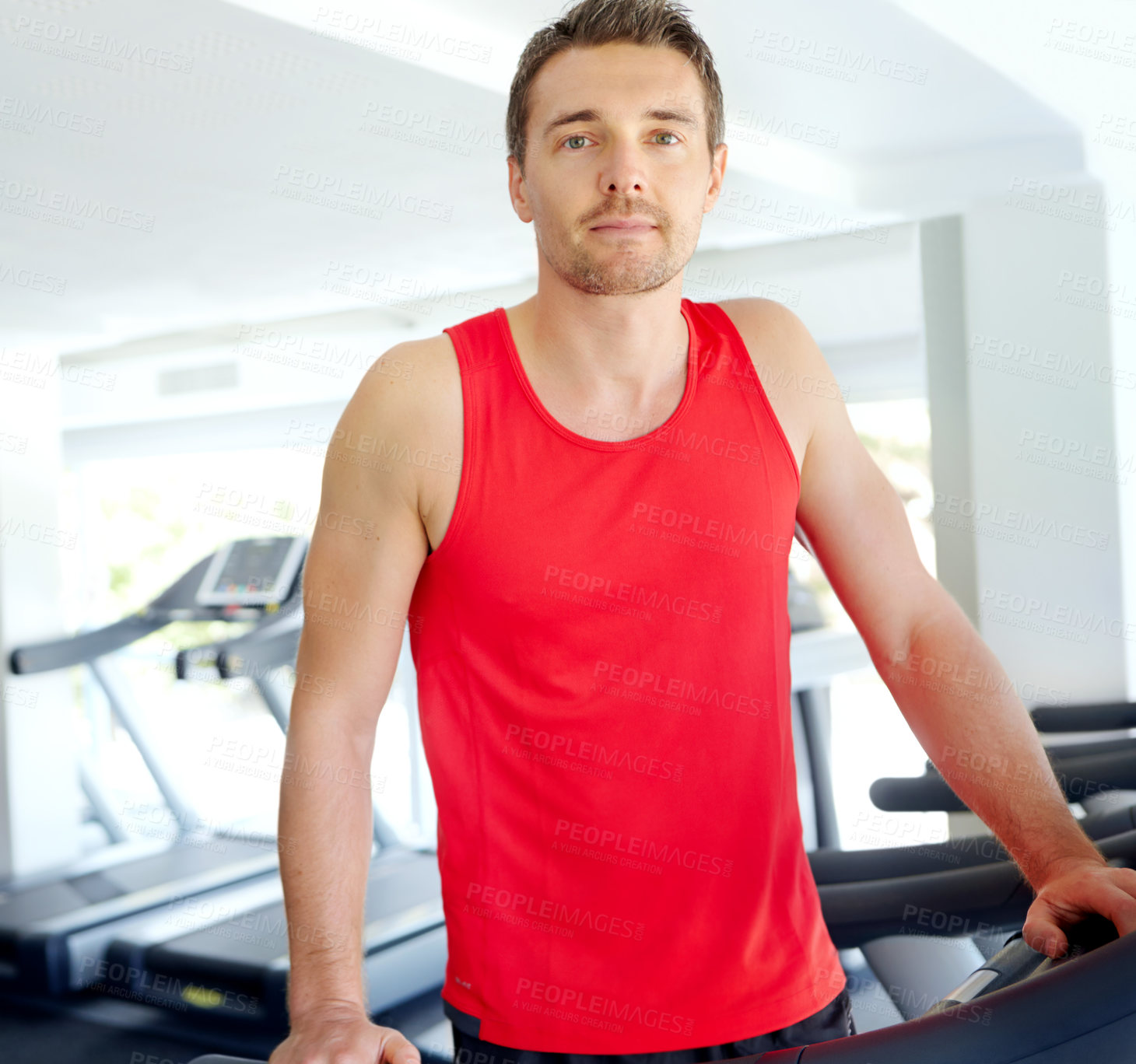 Buy stock photo Runner, fitness and portrait with treadmill for exercise, workout or cardio training in gym. Man, athlete or sports person ready with equipment for endurance, body goals and wellness in health club