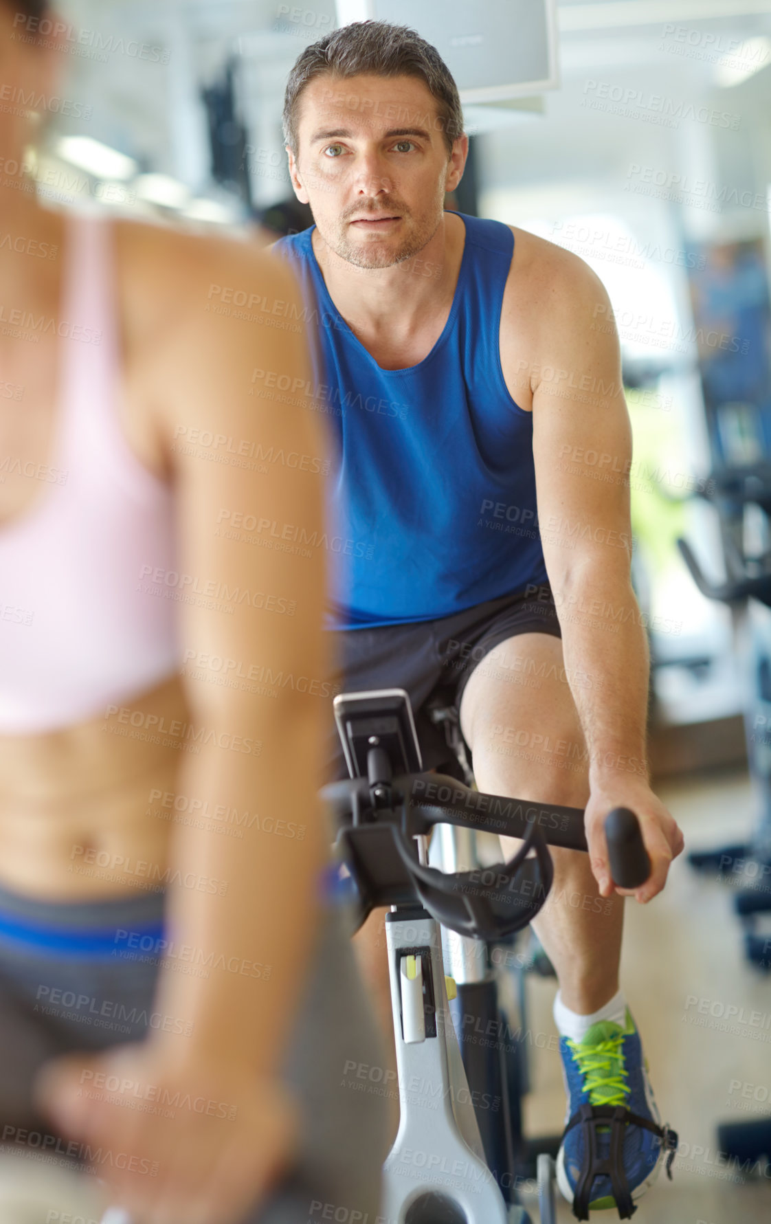 Buy stock photo Cardio, spin class or man cycling on bike machine in training and exercise for wellness, health or fitness. Athlete, active person and bicycle for legs workout, body or endurance in gym challenge